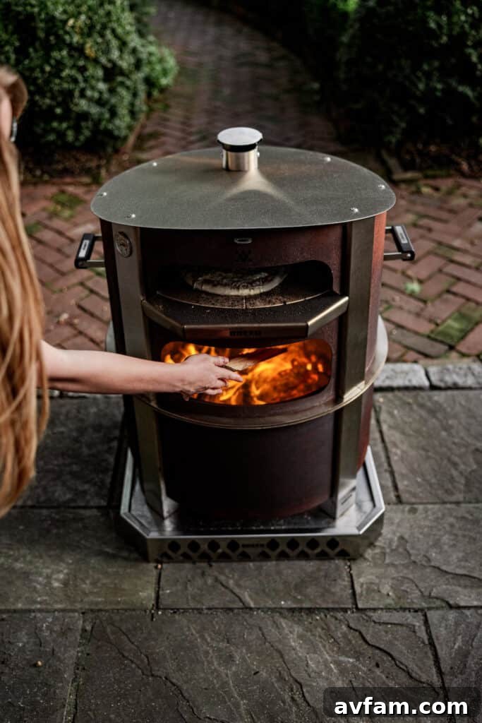 A rustic outdoor kitchen setup featuring the Breeo X24 fire pit and various cooking tools.