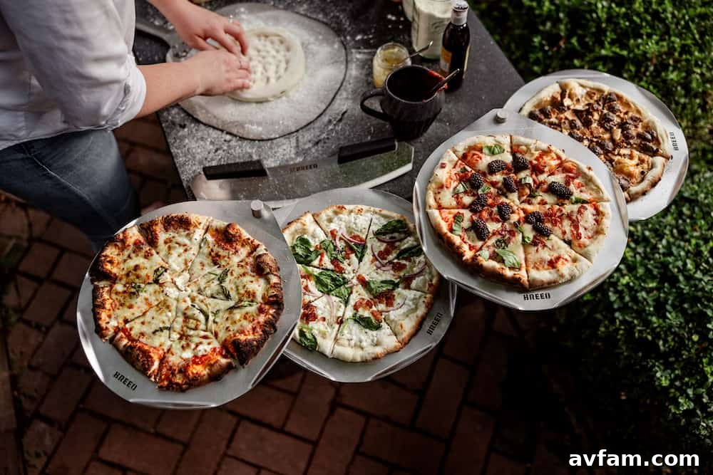 A collection of Breeo accessories, including the pizza peel, serving board, and pizza oven cover, ready for use.