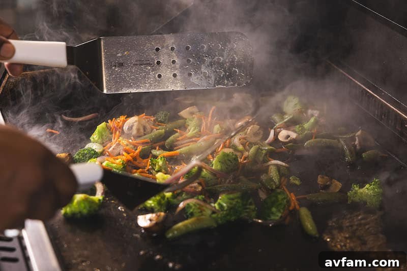 Recteq SmokeStone 600 with food cooking on griddle