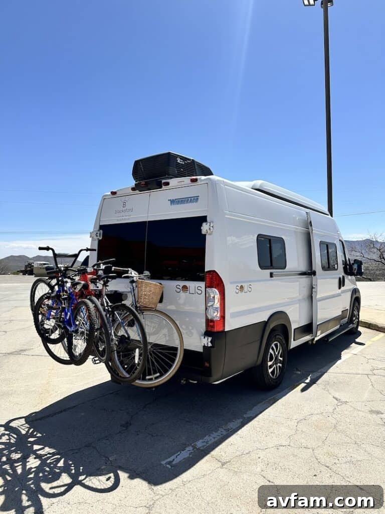 Two children playing outside the Blacksford RV in a scenic setting.