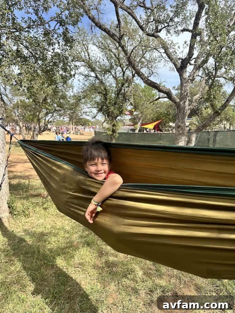 A child peeking out from a Blacksford RV window, enjoying the view.