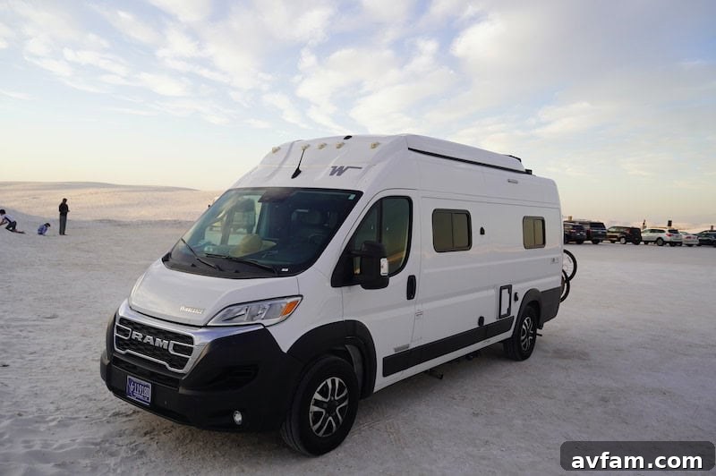 A Blacksford RV parked at a beautiful desert overlook at sunset.