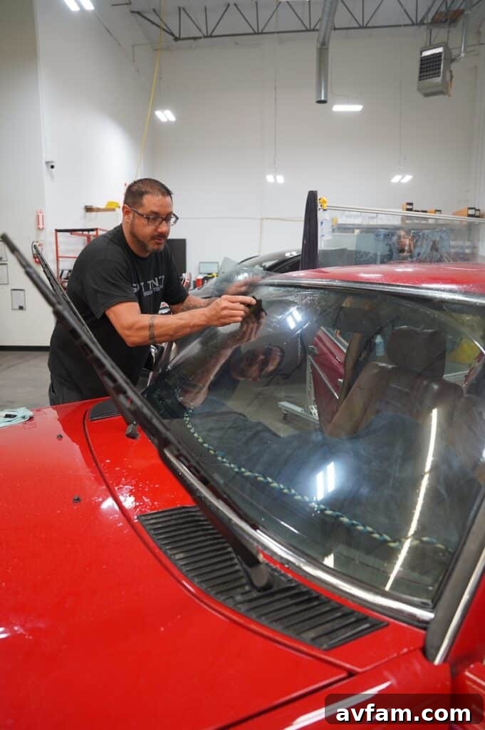 Xpel professional installing window tint on a Mercedes 300D windshield