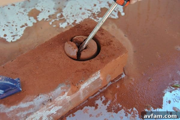 Use a chisel to carefully break away the inner brick core