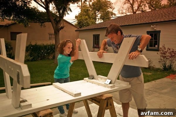 Attaching legs to a picnic table frame during the construction process, illustrating a key step in building.