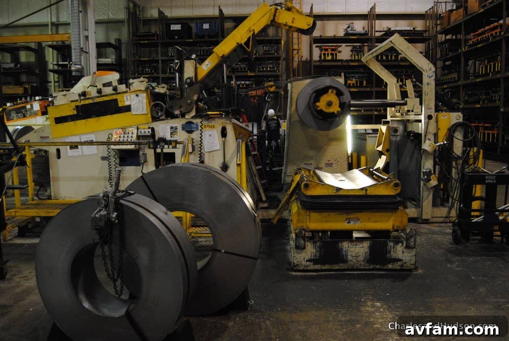 A row of John Deere lawn tractors awaiting their final assembly steps