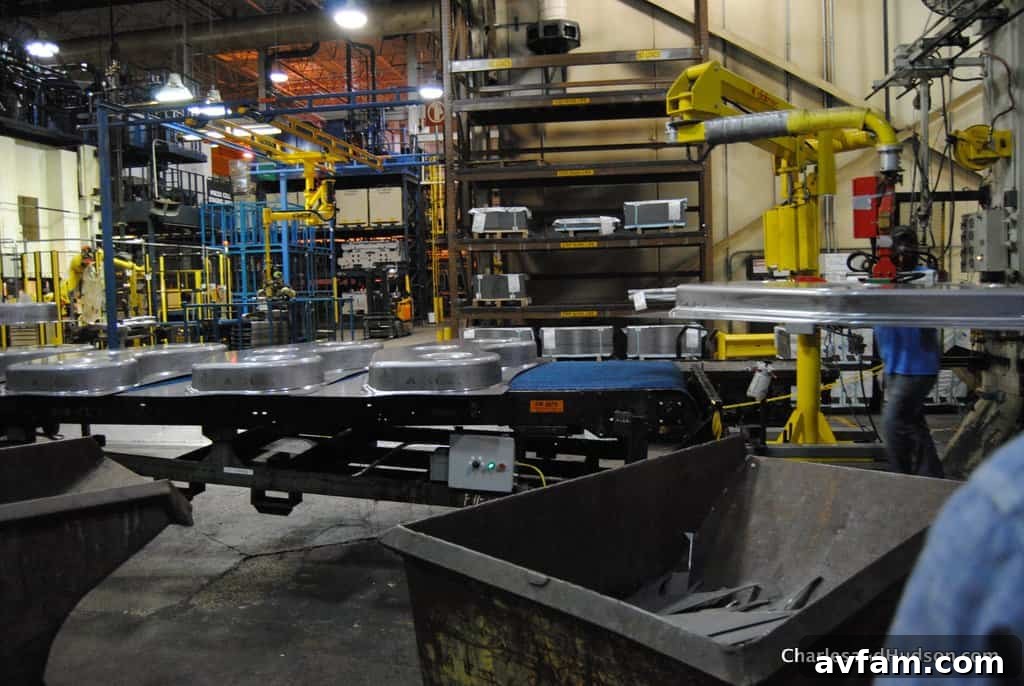 A John Deere zero-turn mower nearing completion on the assembly line