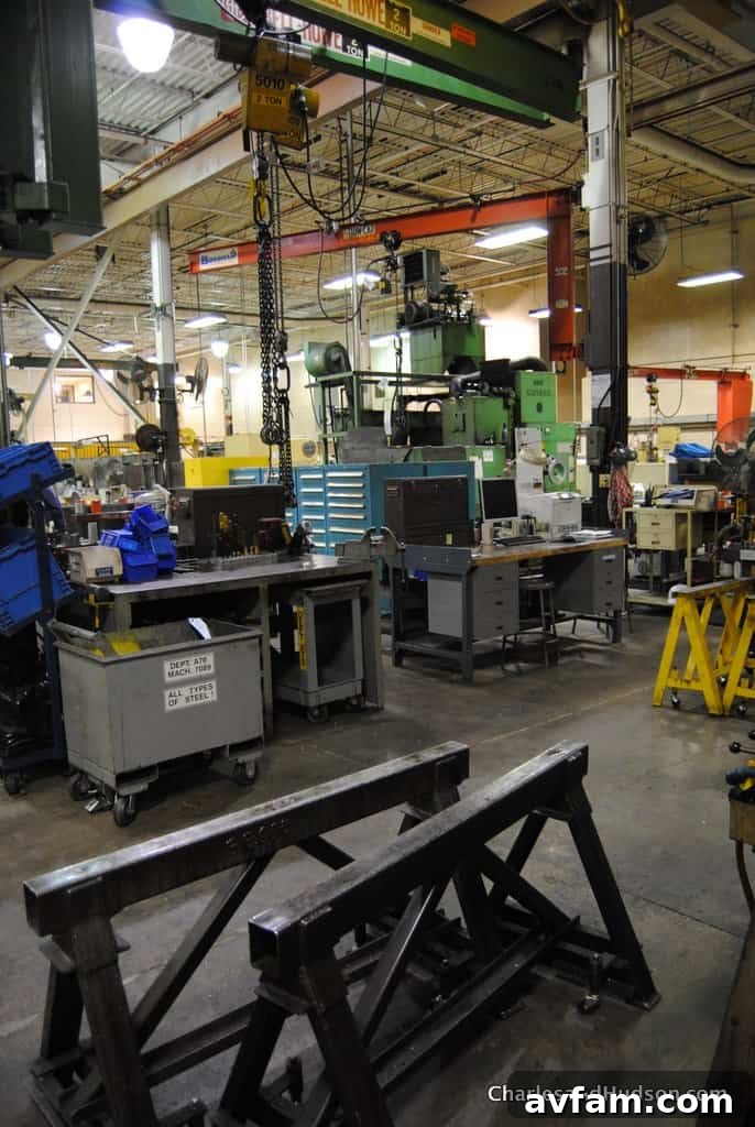 Close-up of precision welding operations on a John Deere component