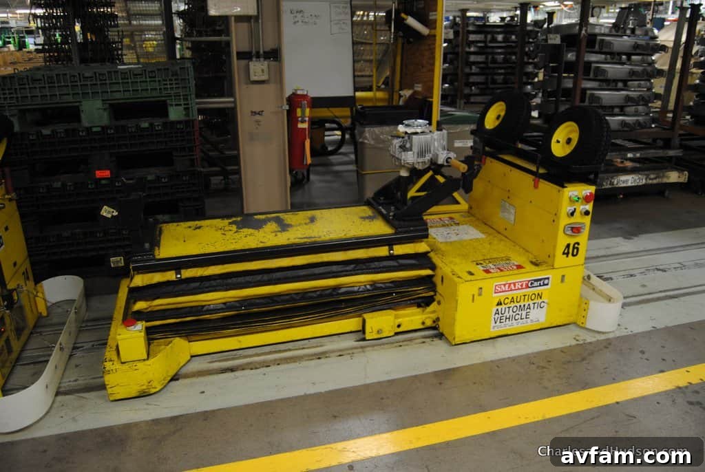 A series of John Deere Gators in various stages of assembly