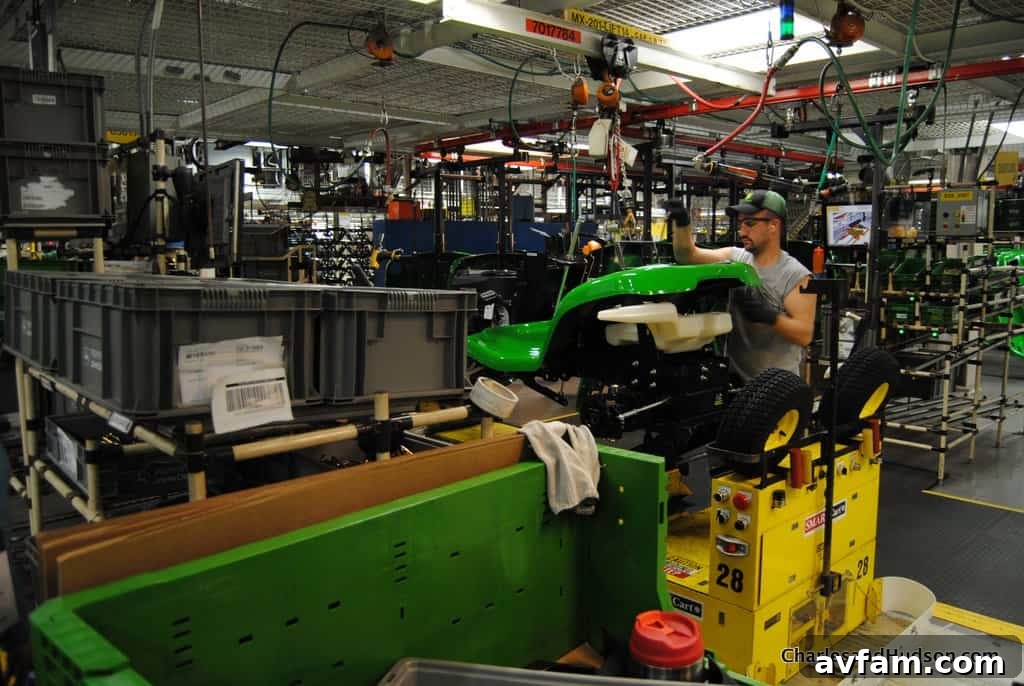 Workers conducting a final performance test on a John Deere lawn mower