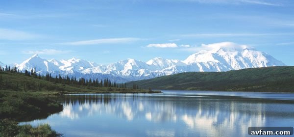 Majestic view of Wonder Lake with Mount Denali in the background, showcasing vast Alaskan wilderness.