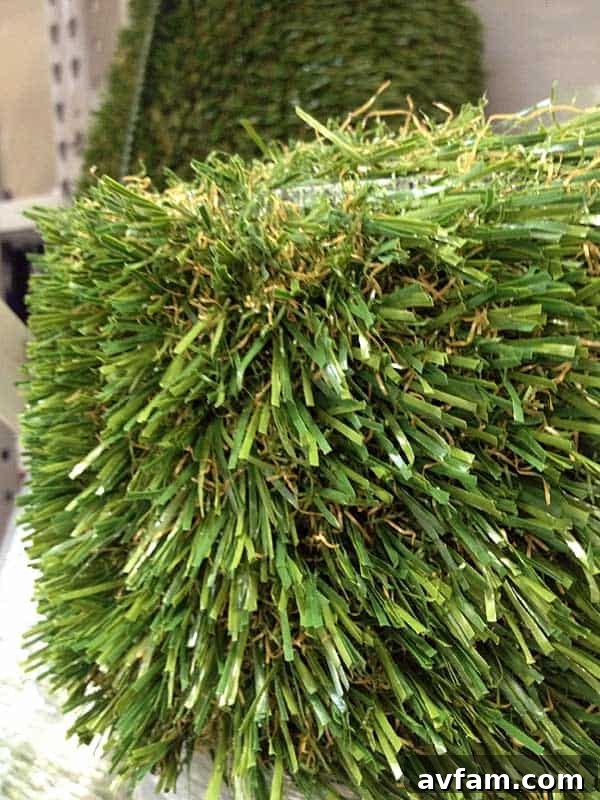 Close-up view of SynLawn artificial grass fibers, showcasing its realistic texture, varied blade lengths, and natural color variations that mimic real grass