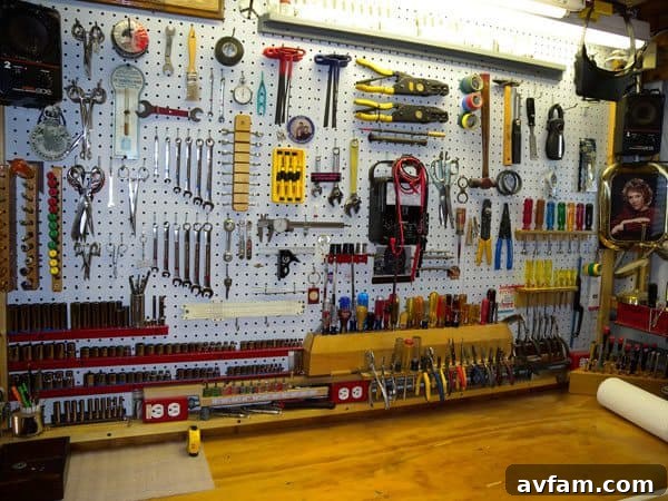 Pegboard wall organization with various hand tools and small bins.