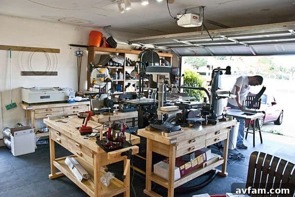 Collection of power tools neatly arranged on a workbench in a garage workshop.