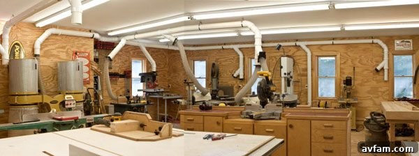 Integrated dust collection system in a woodworking garage workshop.