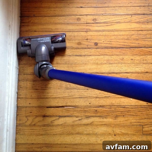 Dyson DC44 Animal tackling corners Dyson DC44 Animal reaching into tight corners and under furniture with ease