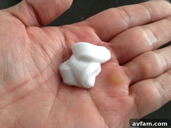 Close-up of GoJo white pumice hand cleaner texture in hand.