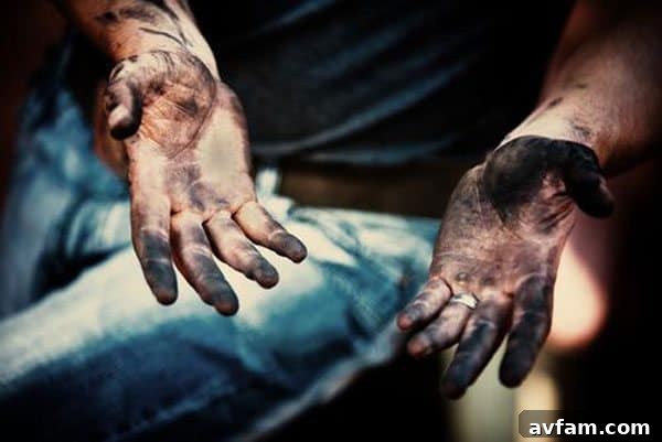 Heavily soiled hands with black grease and dirt, highlighting the need for powerful cleaning.