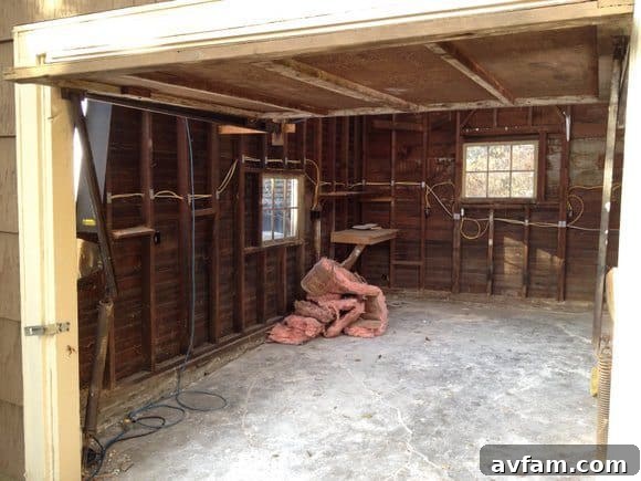 An interior view of the Ram Cave garage before renovation, showing its cluttered and unfinished state