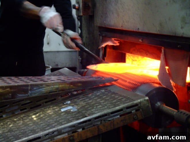 A shovel head emerges red-hot from the forging process at the AMES Camp Hill facility, demonstrating intense manufacturing
