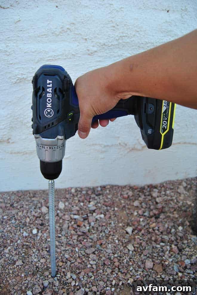 Drilling into Caliche with a Kobalt Drill A person expertly using a powerful Kobalt cordless drill with a masonry bit to bore a clean hole into challenging caliche soil