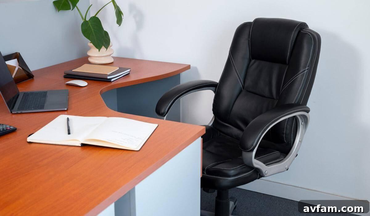 A black office chair beside a wooden desk in a home office setting