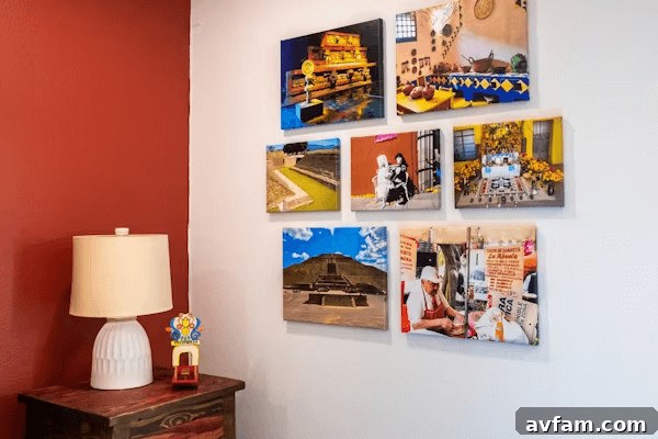 Art hung at eye level above a console table a wall with a lamp and pictures on it