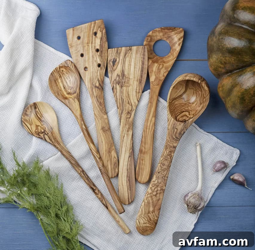 Wood's Wisdom: A Timeless and Natural Upgrade for Your Kitchen 3 Assortment of wooden kitchen utensils including spatulas, spoons, and whisks, arranged on a rustic surface.