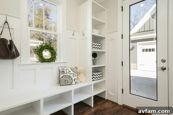 White entryway with bench and mirror, ideal for family organization