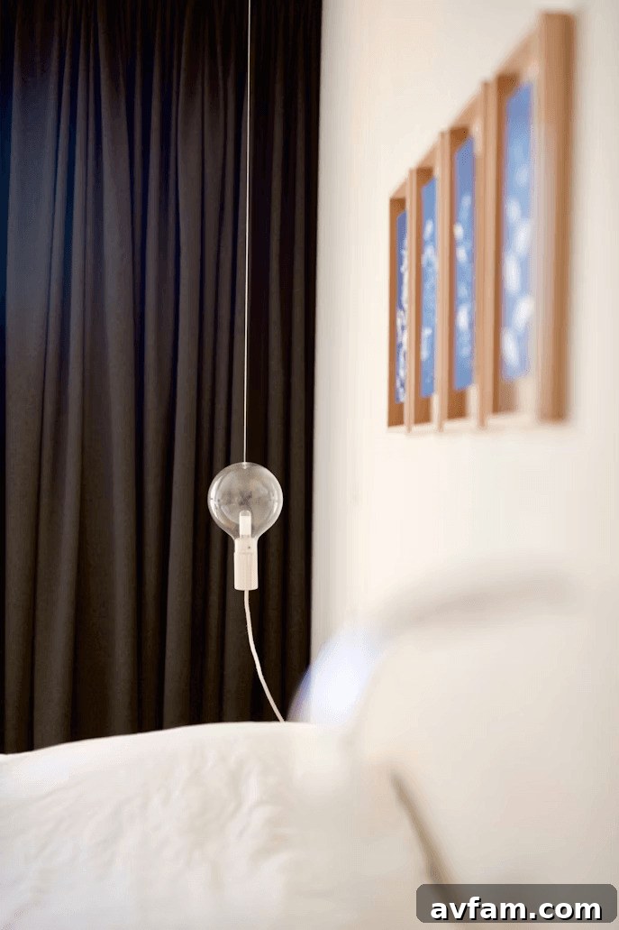 Bedroom with black blackout curtains for improved comfort