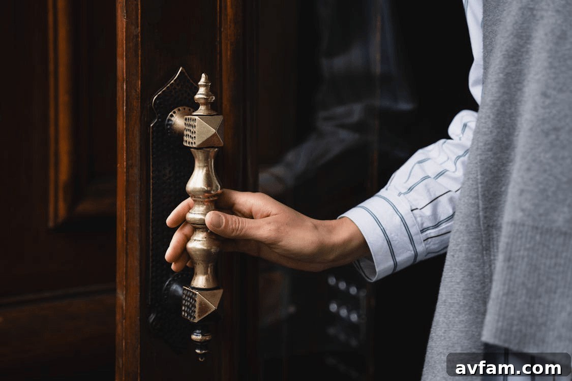 Hand opening a home door, illustrating
