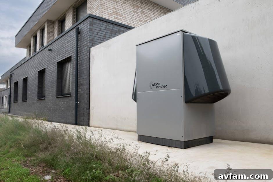 Gray refrigerator sitting outside a building, illustrating an outdoor heat pump unit