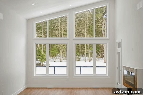 an empty room with a large window and a fireplace