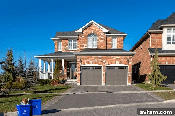Curb Appeal Redefined: Leading Exterior Design Trends 3 Two-story brick house with two garages, showcasing modern garage doors seamlessly integrated into the design.