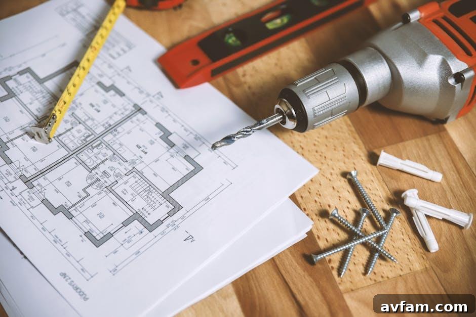 Renovation site in a Southern US home with architectural blueprints and tools laid out