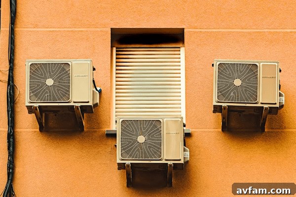 Three air conditioners on building side, highlighting ventilation