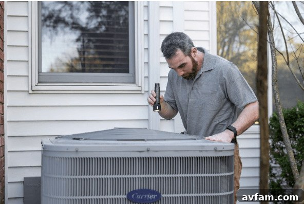 Technician working on an outdoor HVAC condenser unit