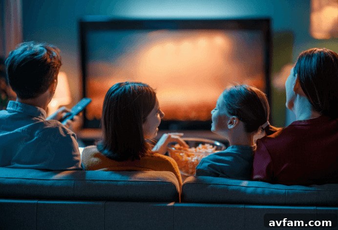 Crafting the Perfect In Home Family Getaway 2 A cozy family entertainment room with a large sectional sofa and a wall-mounted TV