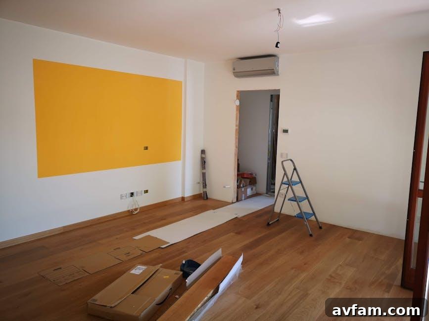 A prefinished hardwood floor being installed in a sunlit living room