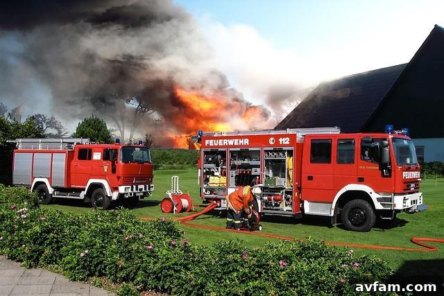 A high-pressure petrol firefighting pump ready for use in a rural setting.