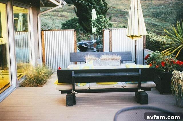 Comfortable patio area with a wooden bench and large umbrellas providing shade.