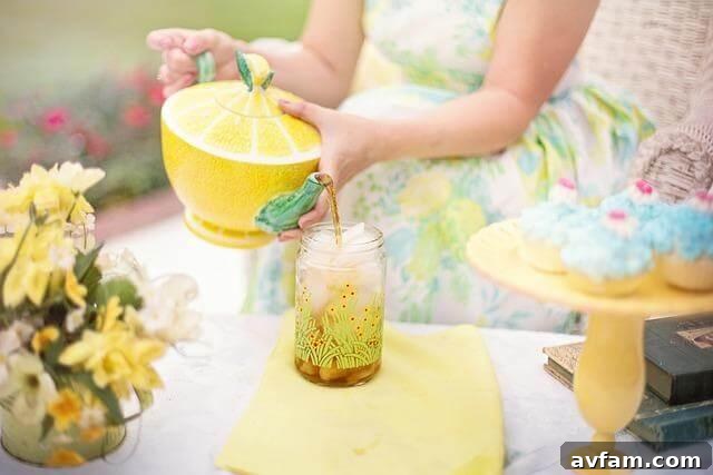 Shake Up Your Steep With 7 New International Tea Day Traditions 4 A woman holding a glass jar containing water and a whole lemon, preparing an infusion