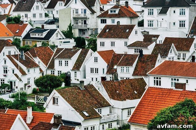 Buying a House in 2026: Strategies to Remove Emotion From the Deal 2 Group of white houses with red roofs, representing