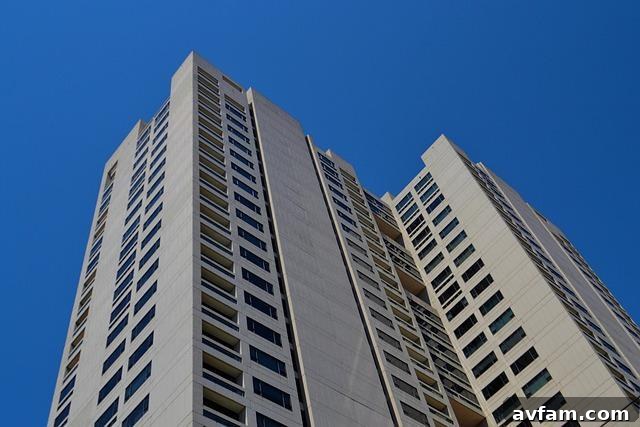 Modern tall building with large windows, representing a