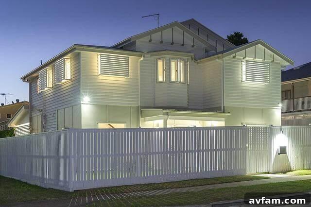White house with a white fence at