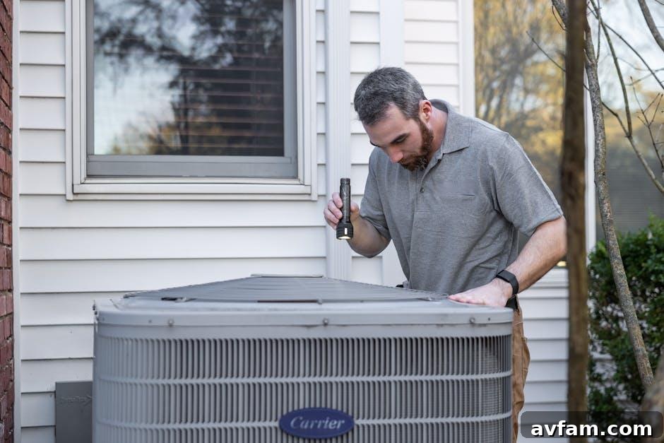 HVAC Maintenance Guide: DIY Tasks vs When to Call a Pro 2 A technician servicing a home air conditioning unit