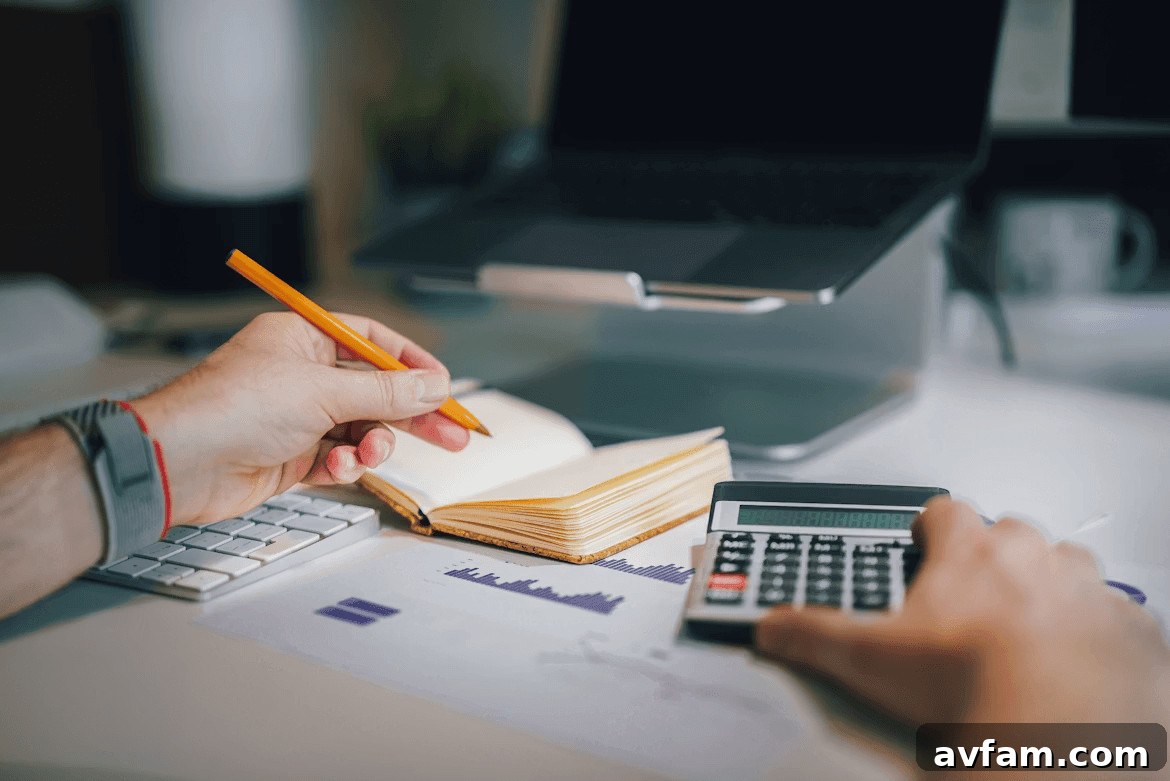 A person calculating renovation budget on a desk with