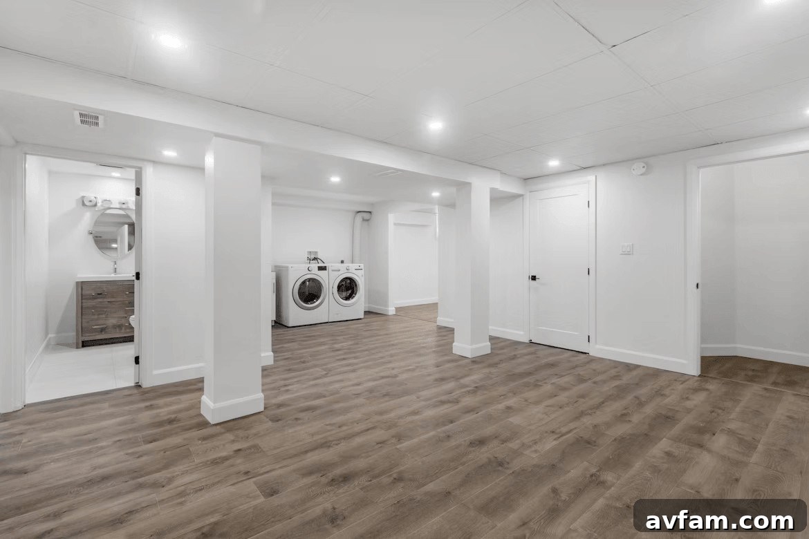 Empty basement laundry room with washer and dryer