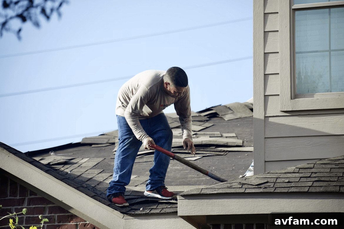 When Homeowners Should Discuss Their Roof Budget 2 Man with a hammer on a roof, discussing