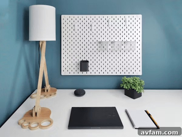 White desk with a laptop, lamp, and space